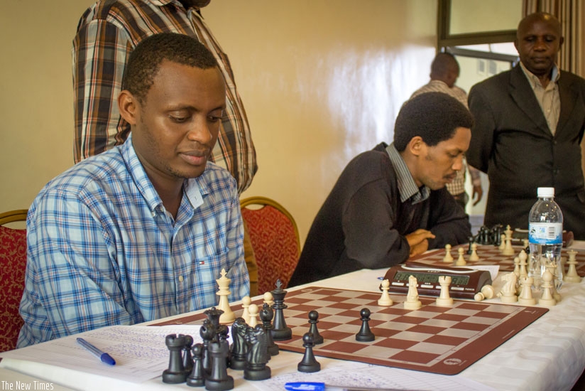 Alain Patience Niyibizi (L), the 2015 male national chess champion, during a past local tournament. Niyibizi and Eagles Chess Club (ECC) team mates are plotting to conquer both home and regional contests. (Courtesy)