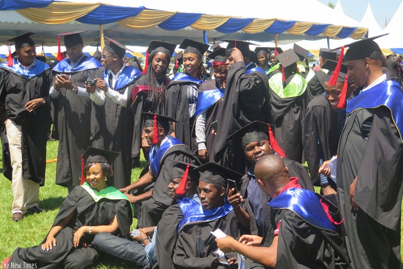 A group of graduates pose for a photo. (Solomon Asaba)