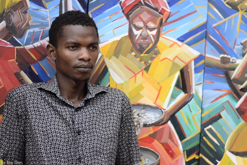 Rukundo stands in front of his three art pieces. (All photos by Sarine Arslanian)