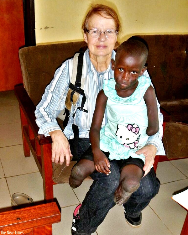 Hronicek with Josiane Iradukunda who lost her limbs after her mother burned and left her for dead. (Courtesy)