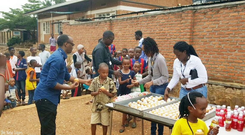 Children receive soft drinks from the Deloitte team during visit.