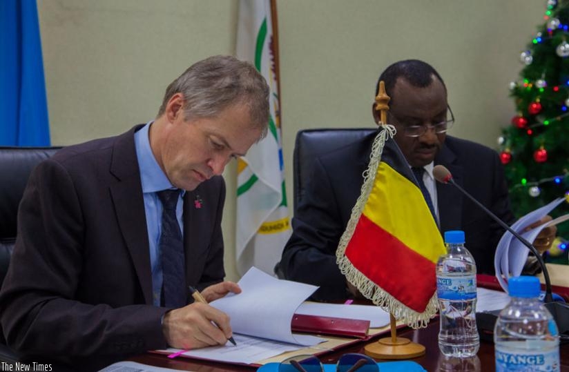 Amb. Pauwels  (L) and Minister Gatete signed  two bilateral development agreements in Kigali, yesterday. (Faustin Niyigena)