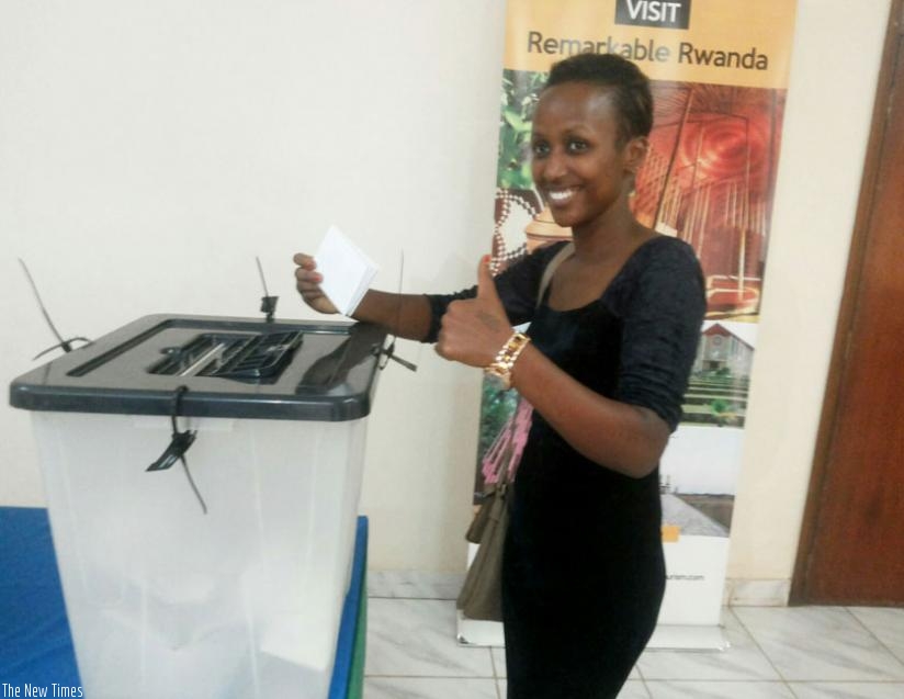 A Rwandan in Kampala smiles while casting her vote yesterday. (Gashegu Muramira)
