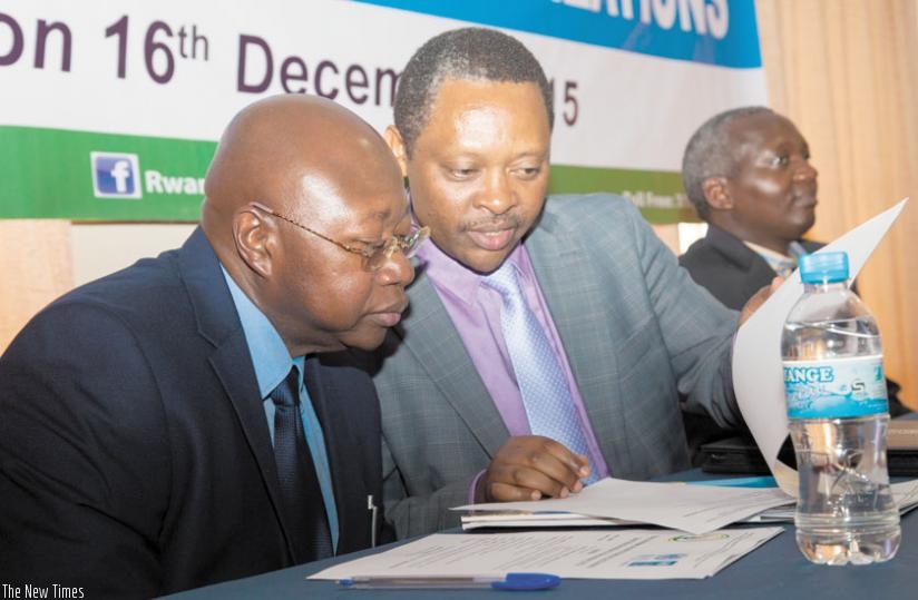 Manneh (L) and Prof. Shyaka read through a document during the meeting in Kigali, this week. (Faustin Niyigena)