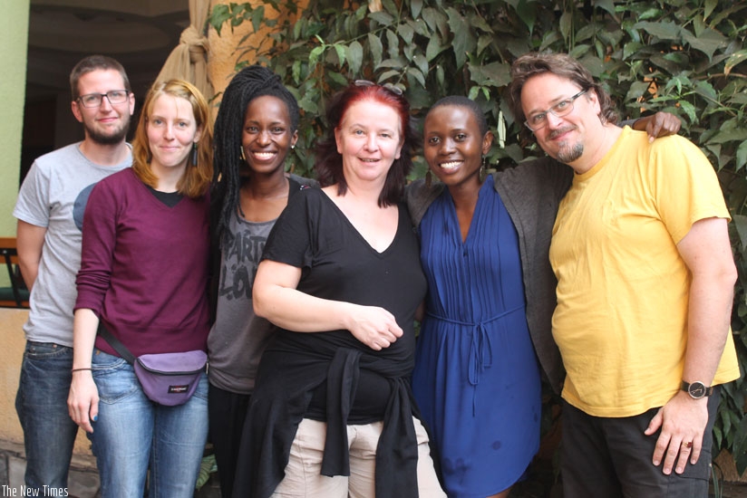 The HELIOS Theater team pauses with local actresses Umuhire Eliane (3rd left) and Nibagwire Dida (3rd right). (Moses Opobo)