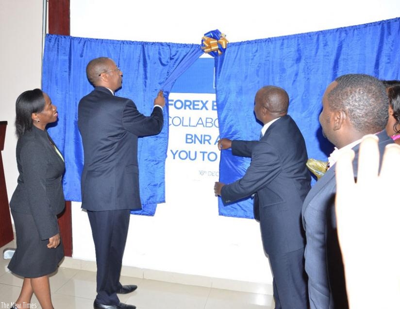 Rwangombwa and Muhigi launch the Rwanda Forex Bureau Association as the BNR vice-governor, Dr. Monique Nsanzabaganwa (left), looks on.  The association is expected to help streamline the foreign exchange sub-sector in the country. (Courtesy)