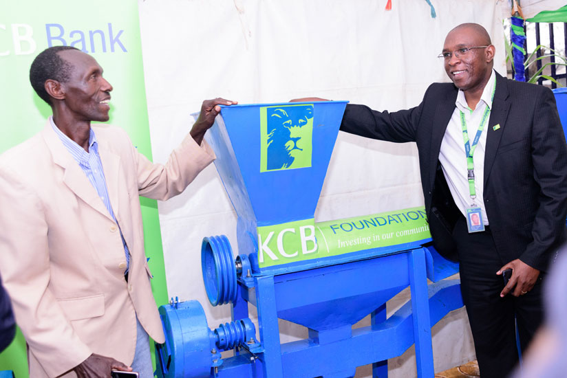 Odhiambo hands over one of the maize shelling machines to a farmer in Kayonza last week. (Courtesy)