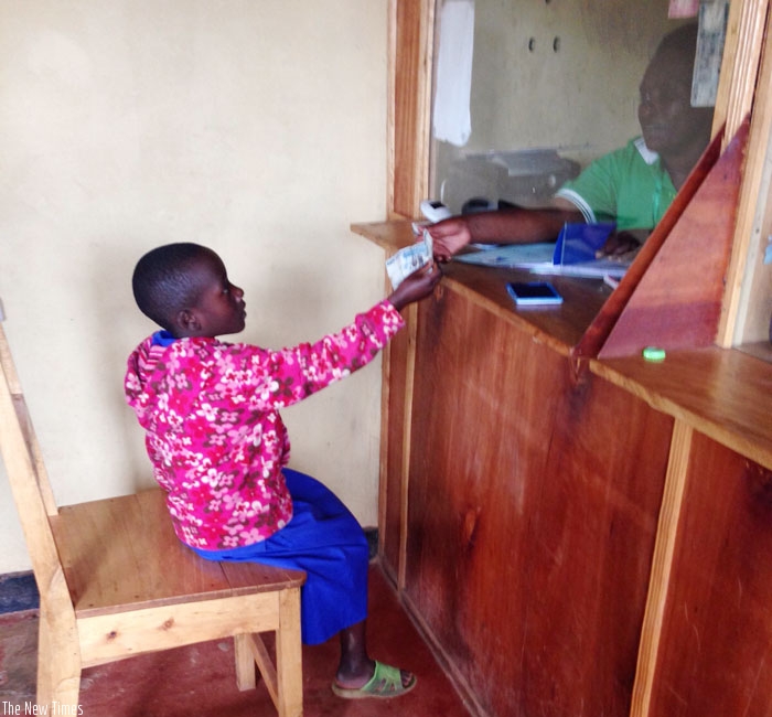 A child withdraws money at a micro finance. The sector has registered a slight increase in bad loans. (Net photo)