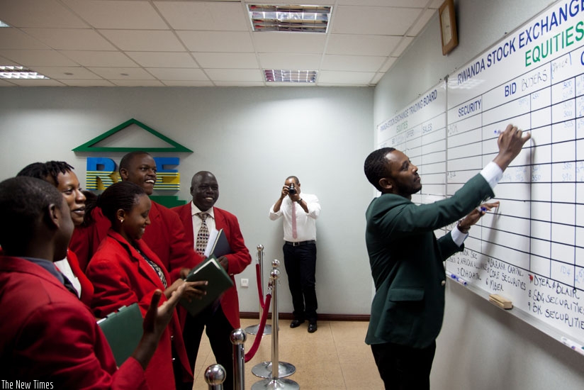 A broker updates trading on the local stock market. Rwandans in the Diaspora have expressed ambition to invest in local stock market. (File)
