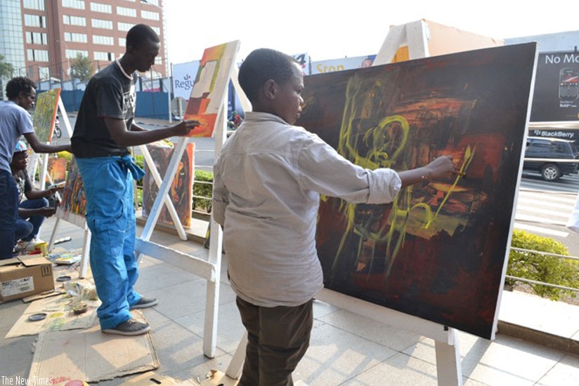 Fabian Akimana, (right) at a previous art exhibition. (Courtesy)