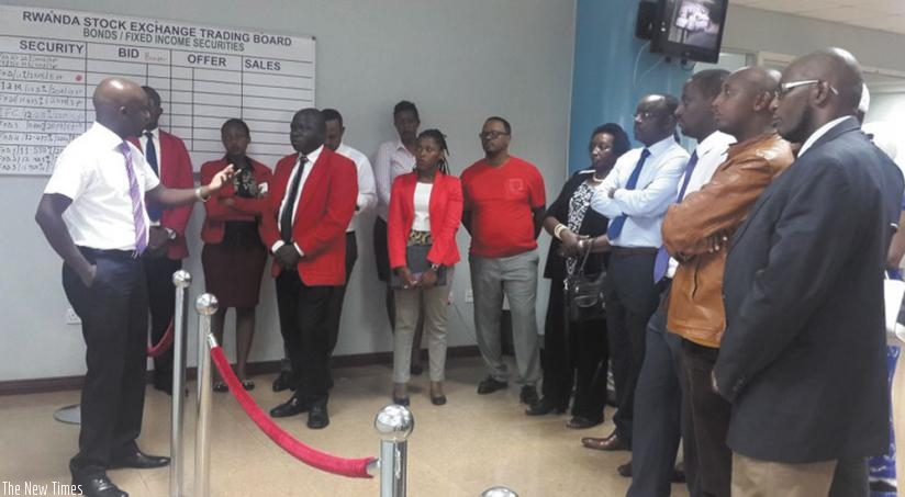 Celestin Rwabukumba (left), the Rwanda Stock Exchange (RSE) chief executive, addresses the diaspora at the bourse trading floor on Wednesday. (Courtesy)