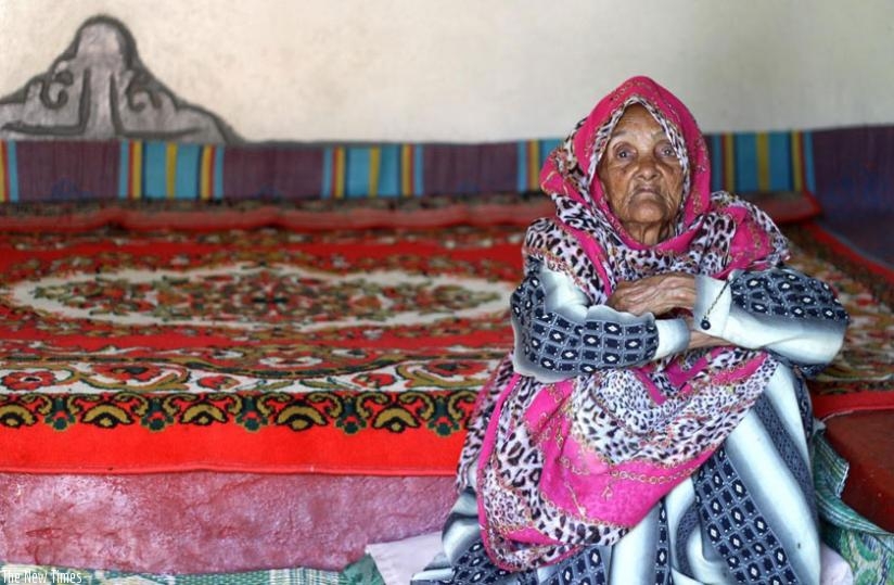 An old Harari woman sitting in the living room of her traditional house.