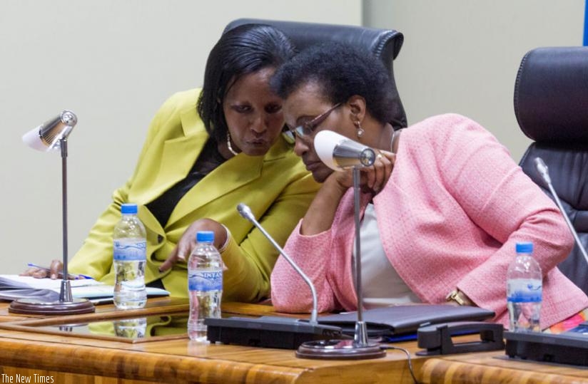 Gender and Family Promotion minister Oda Gasinzingwa (L) consults with Speaker Donatille Mukabalisa at Parliament yesterday. (Timothy Kisambira)