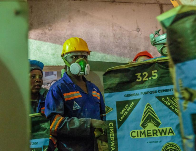 Cimerwa employees operate a cement production line at the firmu2019s plant in Rusizi. EAC industrialists want more support from leaders to improve output. (File)