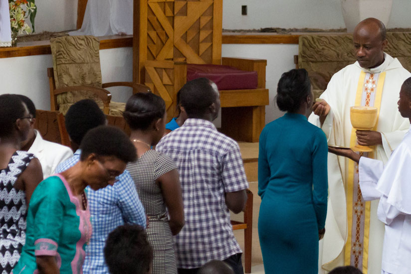 Father Casimir Uwimukiza of St Michel church conducts Holly Communion during a church service  yesterday. (All photos by Timothy Kisambira)