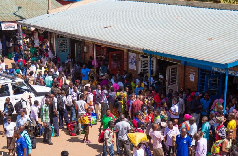 Passengers queue to pay for transport at Nyabugogo bus terminal yesterday. (Timothy Kisambira)