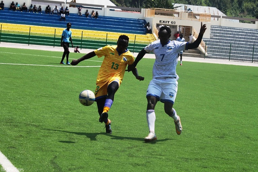Yousouf Habimana (left) of Amavubi A tustles with Amavubi B's Muhamed Mushimihiyimana on Sunday at Umuganda stadium. (Courtesy)