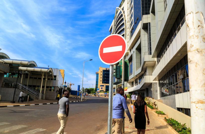Pedestrians walk through the car free zone at KN Avenue Street in the central Business district Kigali. (Timothy Kisambira)