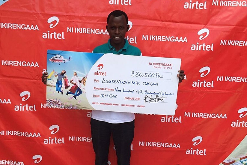 Dusabendayambaje poses with a dummy cheque of the money he won on Tuesday. (Courtesy photo)