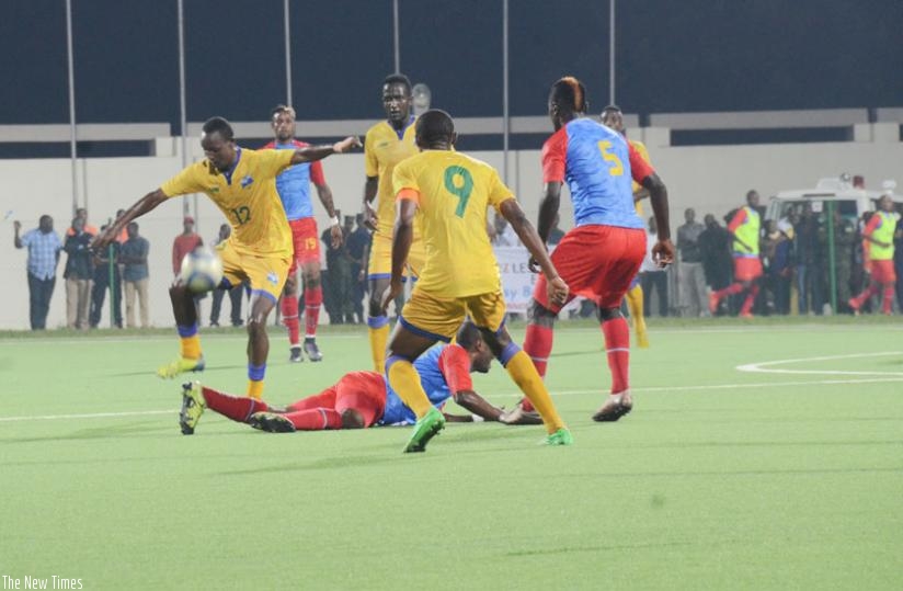 Jean Claude Iranzi (number 12) and skipper Jacques Tuyisenge  on the ball try to break down DR Congo defence at Umuganda stadium yesterday. (Sam Ngendahimana)