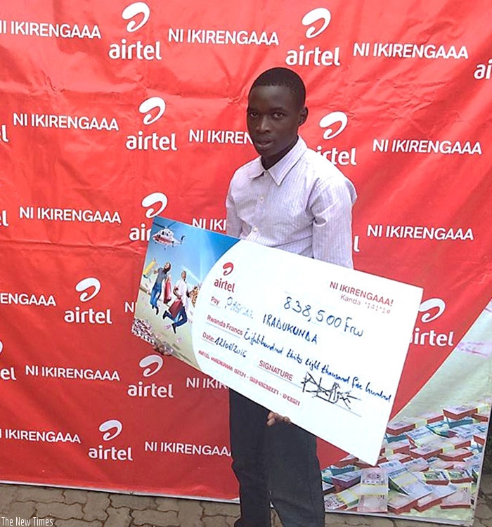 Iradukunda poses with a dummy of the Rwf838,500 cash he won on Tuesday. He says he will use part of the money to start an income generating project.  (Courtesy)