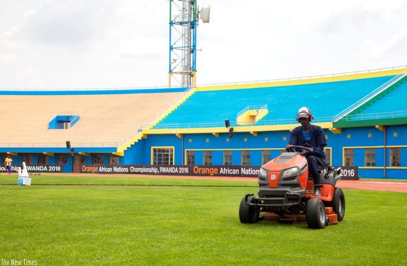 A groundsman mows grass on the turf at Amahoro National Stadium, host venue for the opening ceremony and kickoff match on Saturday. (Faustin Niyigena)