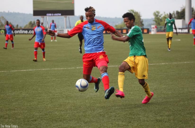 Congo's Jonathan Bolingi Mpangi battles with Ethiopia's Tekalign De Jene at Huye Stadium on Sunday. (S. Ngendahimana)