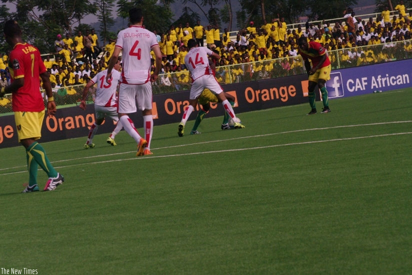 Tunisia's Mohamed Ben Amor tries to steal the ball from a Guinean defender earlier today (Peter Kamasa) 