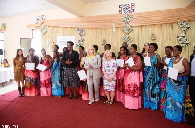 First Lady Jeannette Kagame and Francine LeFrak, the founder of Same Sky, a cause-based trade initiative that provides training and employment for HIV-positive women survivors of the 1994 Genocide against the Tutsi (to her left), and Karen Yelick, a Same Sky official, in a group photo with the Avega graduates. (Courtesy)