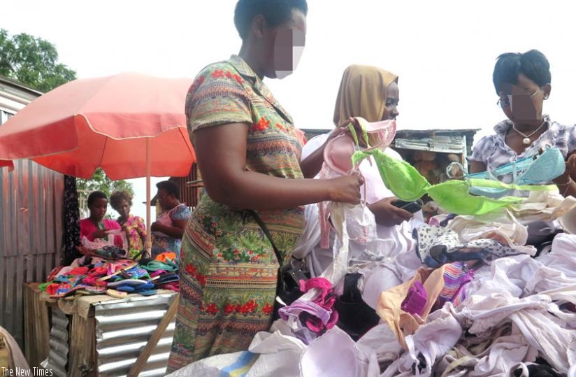 A used bra seller (L) helps her clients make choices in Nyamirambo Market. (Michel Nkurunziza)