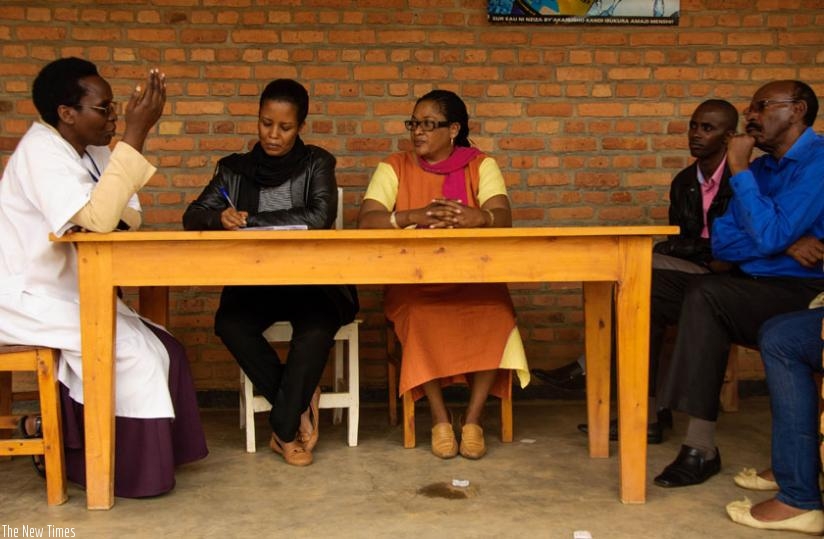 Kankesha (L) briefs MPs Nikuze, Mukazibera, and Mudidi (R) during  a discussion about malnutrition on Tuesday as Alfred Mukiza, the executive secretary of Niboye Sector (2nd R) looks on. (Teddy Kamanzi)