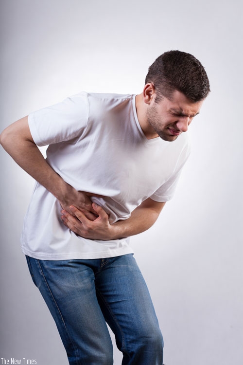 A man in pain holds his stomach. (Net photo)