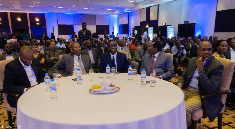 Foreground: Rwangombwa, Gatera, John Rusagara of the Shippers Council, as well as John Mirenge, the RwandAir CEO, and other customers (background) listen to presentations at the function. (Teddy Kamanzi)