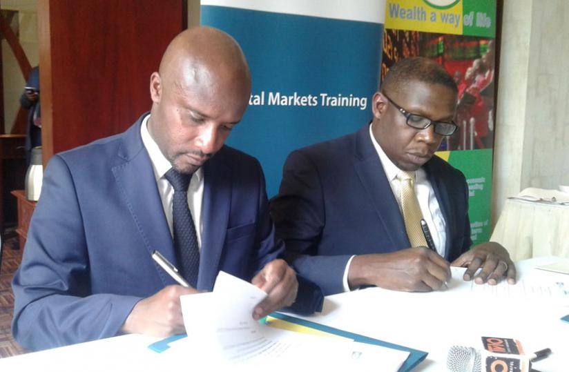RSE chief Celestin Rwabukumba (left) and NSE's Geoffrey Odundo sign a partnership agreement on Friday. (File)
