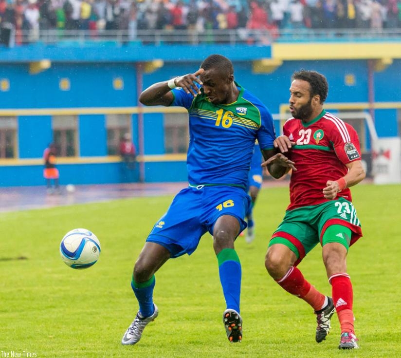 Amavubi forward Ernest Sugira, shields the ball from Morocco defender Issam Erraki on Sunday. Rwanda lost the game 4-1. (T. Kisambira)