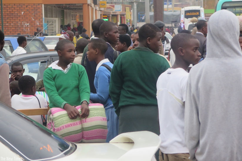 Students at Nyabugogo bus terminal waiting for a bus. It is advisable that students depart for school early to be able to reach in good time. (Solomon Asaba)
