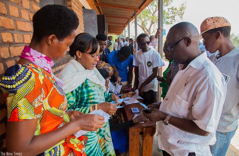 Voters search for their voter cards at Sainte Famille polling station during the referendum elections in Kigali, last year. (File)