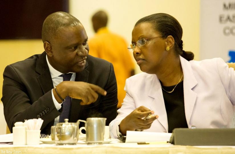 Benjamin Gasamagera, the chairperson of Private Sector Federation (L), chats with Amb. Valentine Rugwabiza, the minister for East African Community affairs, at a breakfast meeting between the ministry and business leaders in Kigali yesterday. (Timothy Kisambira)