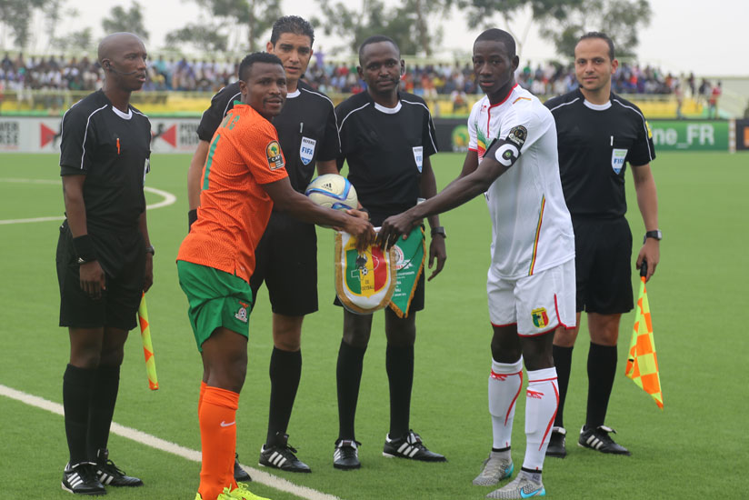 Zambia captain, Christopher Katongo (2nd left) and Mali captain Karim Dante (2nd right) exchange pennants before kick off earlier today (Peter Kamasa)