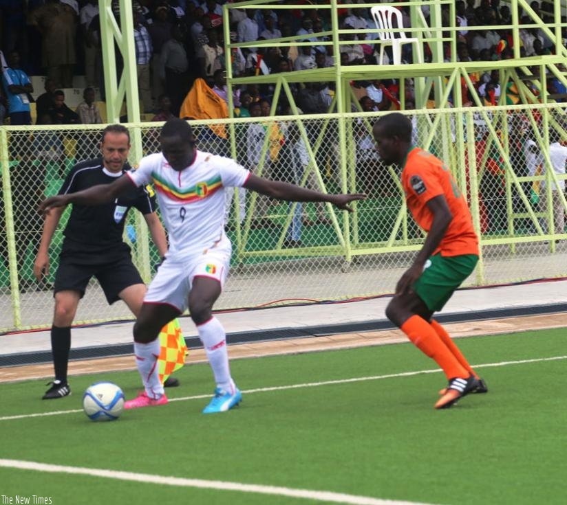 Striker Hamidou Sinayoko of Mali shields the ball from a Zambian defender during their final Group D match. Both teams advanced to the last eight. (P. Kamasa)