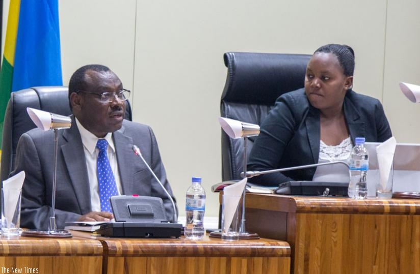 Minister Gatete (L) presents to Parliament the revised 2015/16 National Budget yesterday, as Jeanne d'Arc Uwimanimpaye (R), deputy speaker in charge of legislation listens. (Doreen Umutesi)