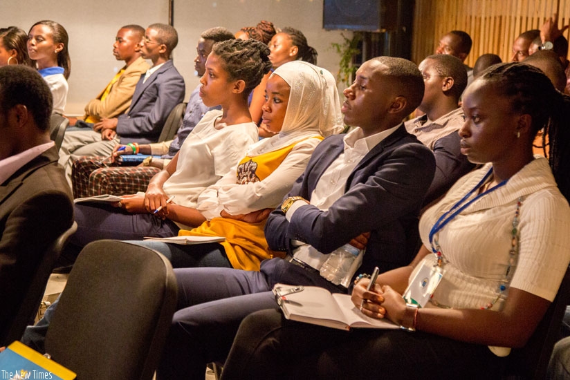 Participants at the Youth Connekt Dialogue on heroism listen to a testimony from a survivor of the 1997 Nyange school attack. (Doreen Umutesi)