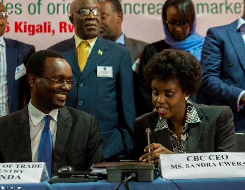 Emmanuel Hategeka (L), the permanent secretary at Trade and Industry ministry chats with Sandra Uwera, the Chief Executive Officer, COMESA Business Council. (Timothy Kisambira)