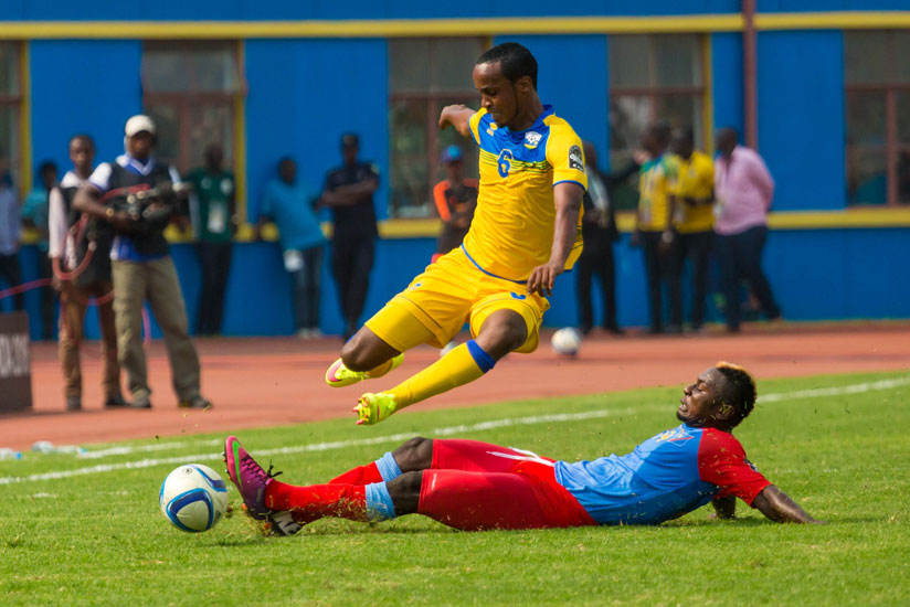 Amavubi's mid-fielder Yannick Mukunzi  jumps to avoid a tackle from a Congolese defender. (Timothy Kisambira)
