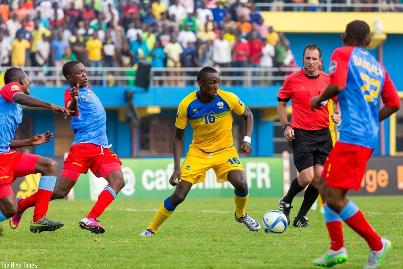 Amavubi striker Ernest Sugira (C) takes on Congolese defenders. The striker score the only goal for Amavubi. (Timothy Kisambira)
