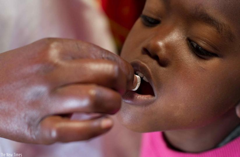 A child taking a deworming tablet. (Net photo)