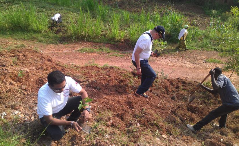 Kigali Marriot Hotel staff plant trees during Umuganda (community work) in Kinyinya on Saturday. (Frederic Byumvuhore)