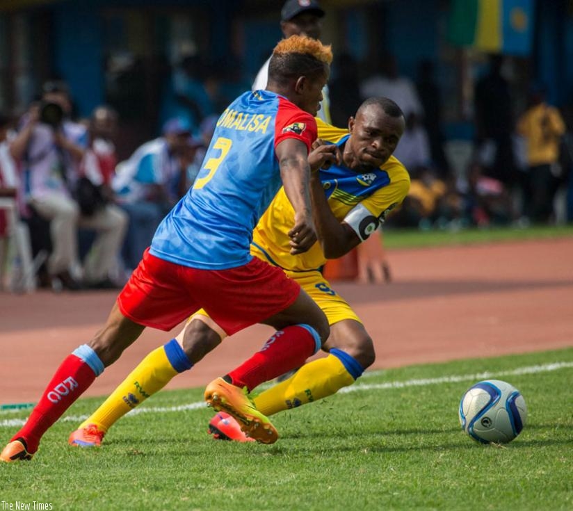 Amavubi captain, Tuyisenge races for the ball with DR Congo defender Omalisa on Saturday. DRC eliminated Rwanda in the quarter-final. (T. Kisambira)
