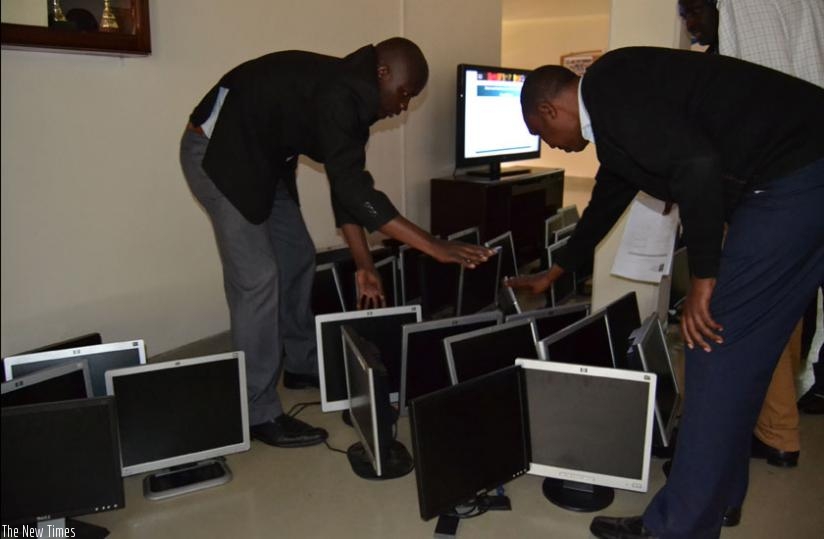 Head teachers count computers which were refurbished by Tumba College of technology, lastweek. (Jean d'Amour Mbonyinshuti)