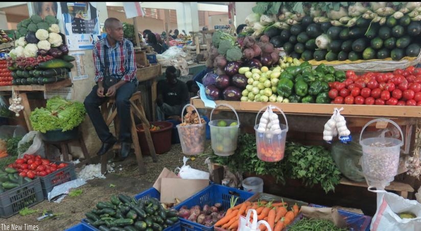 Vegetable vendors waits for customers at City Market in Nyarugenge District in the May, 2015 photo. Prices of most vegetables were stable over the past month, while those of potatoes increased by Rwf80 and Rwf100. (File)